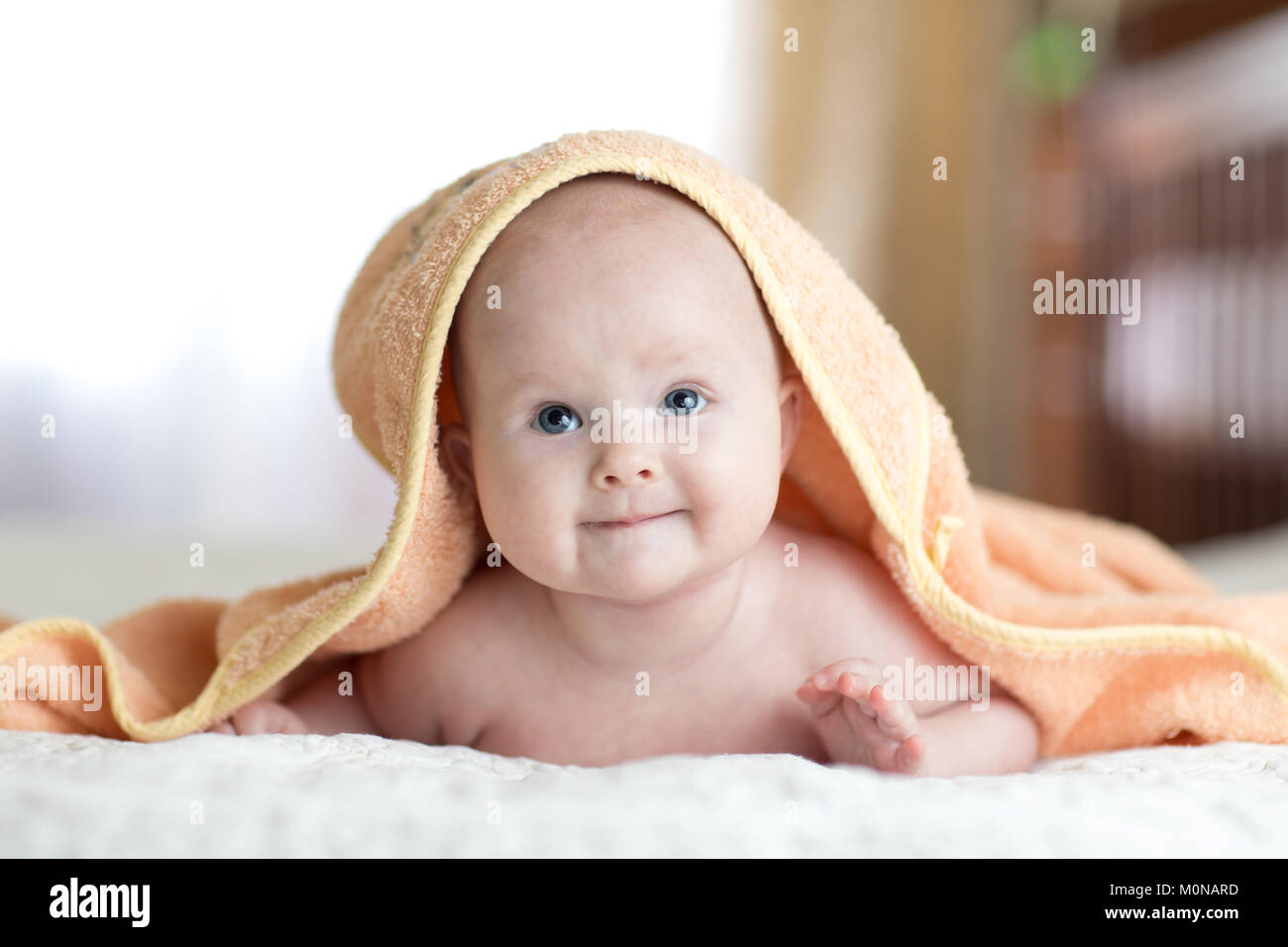 Four months baby girl lying wrapped towel after bathing Stock Photo Alamy