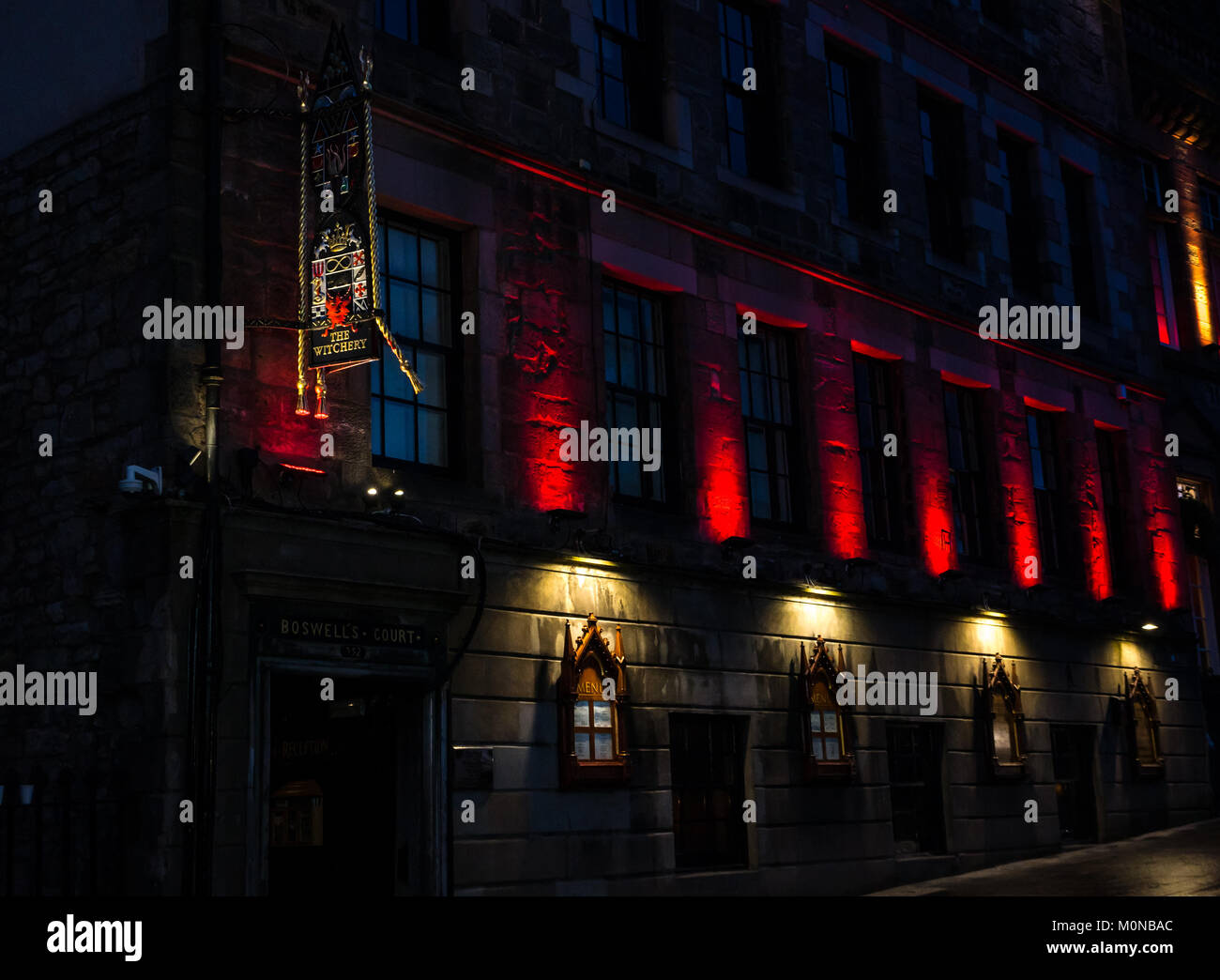 Dramatic red night lights and sign, The Witchery restaurant, 16th century Boswell's Court, Castlehill, Royal Mile, Edinburgh, Scotland, UK Stock Photo