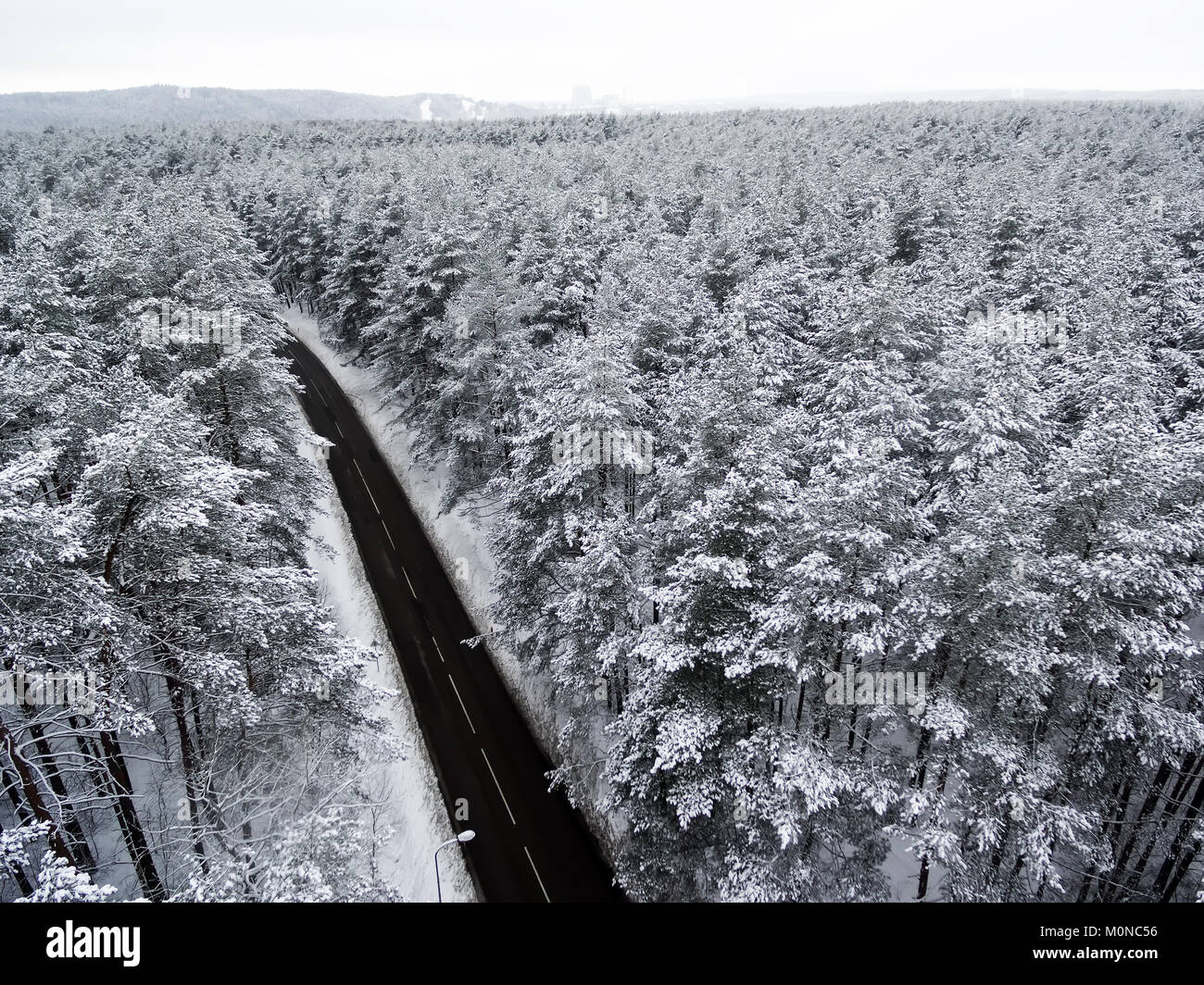 Aerial top view of road in winter forest Stock Photo