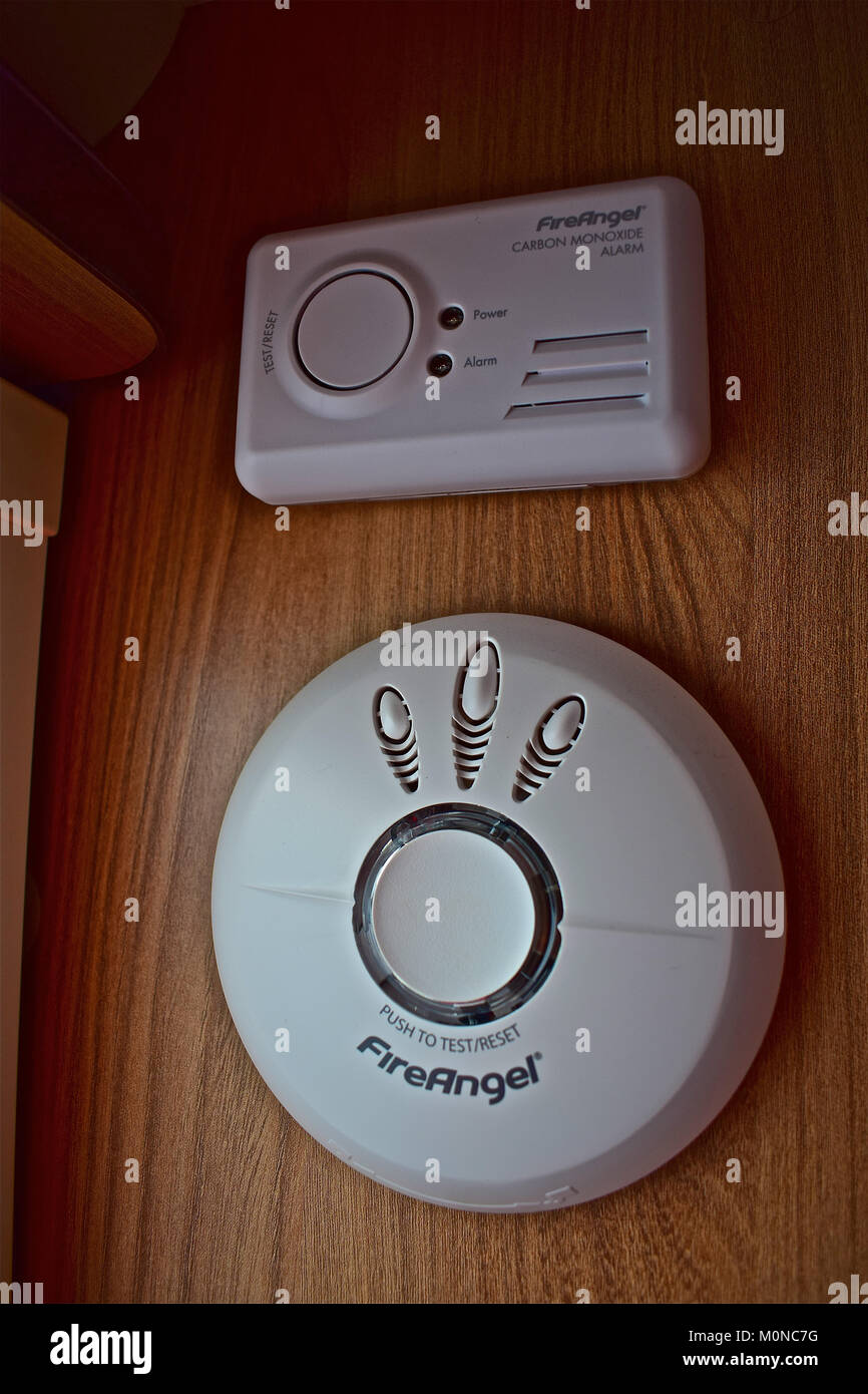 FireAngel smoke alarm (bottom) and carbon monoxide detectors as fitted in modern caravans/ motorhomes fitted high up as the gases are lighter than air Stock Photo