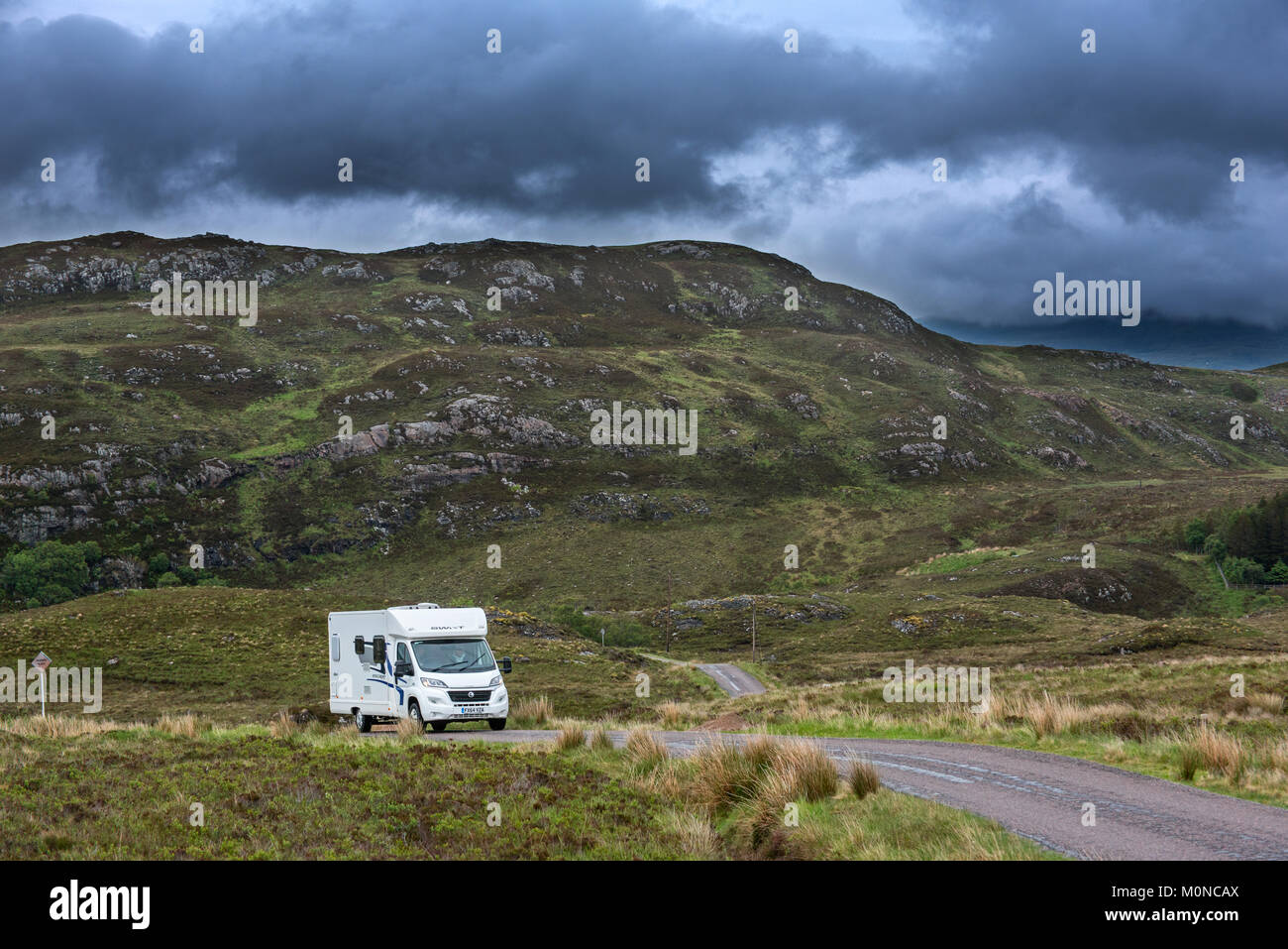 Motorhome / campervan driving along winding single track road with passing places in the Scottish Highlands, Ross-shire, Scotland, UK Stock Photo