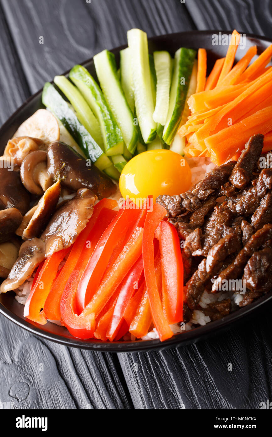 Delicious Korean food Bibimbap with beef, yolk, vegetables, mushrooms