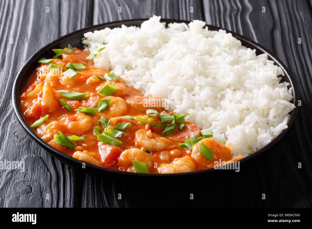 American cuisine spicy gumbo with prawns, sausage and rice closeup on