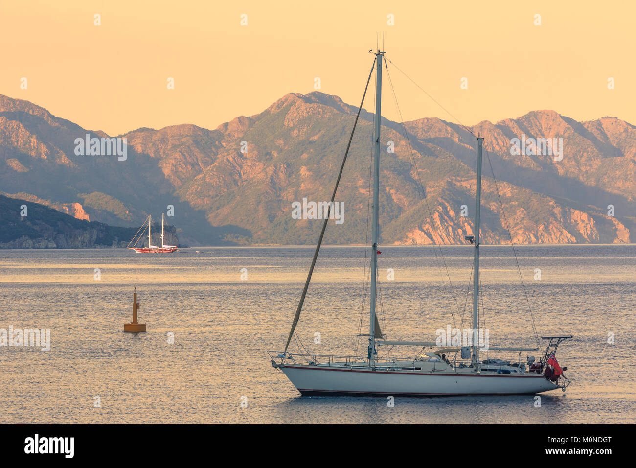 Beautiful seascape with sailing boat during sunrise in Turunc province in Marmaris, Turkey Stock Photo