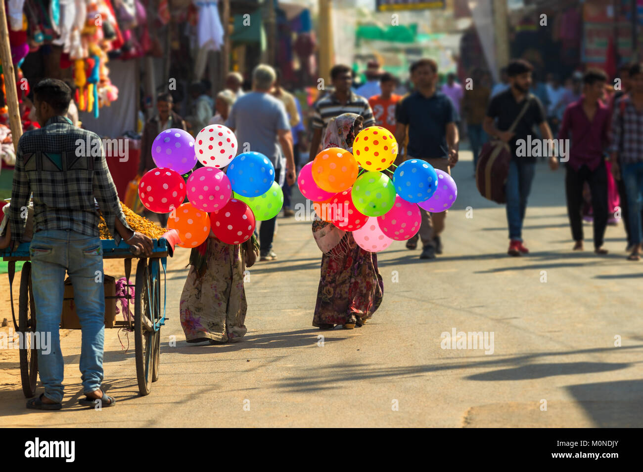 Children sell colorful balloons in Pushkar during Pushkar Camel Fair Stock Photo
