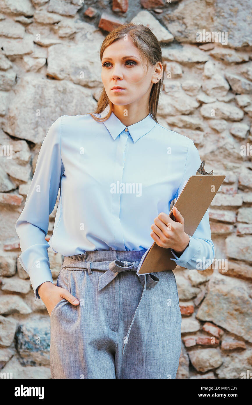 Serious businesswoman holding clipboard Stock Photo