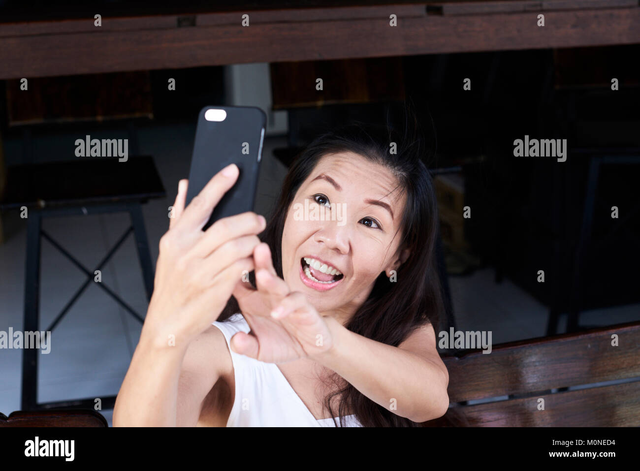Happy senior brunette business woman taking a self-portrait at work. Stock Photo