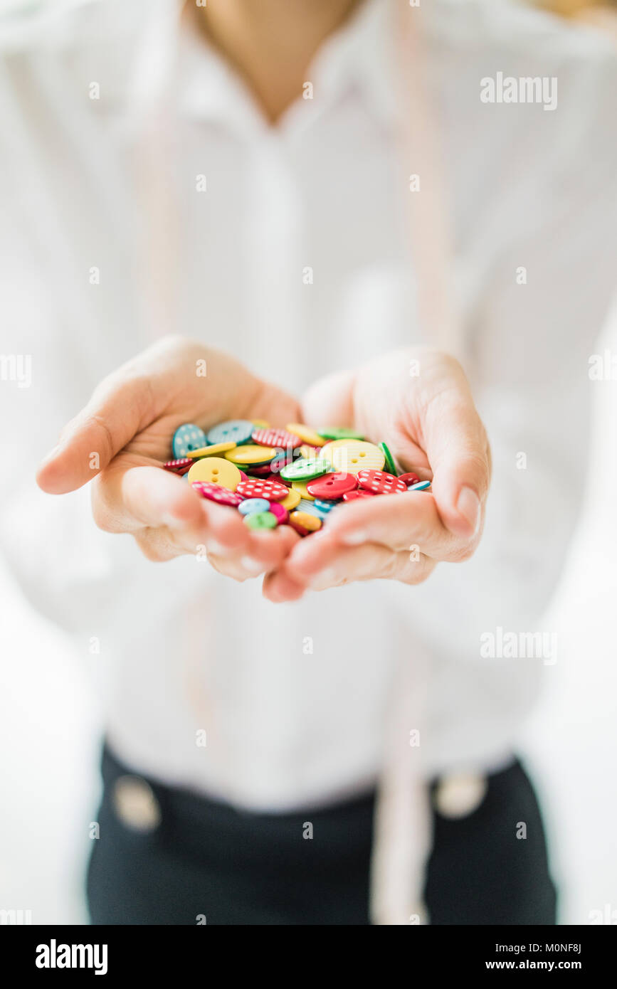 Assortment of buttons in woman's hands Stock Photo