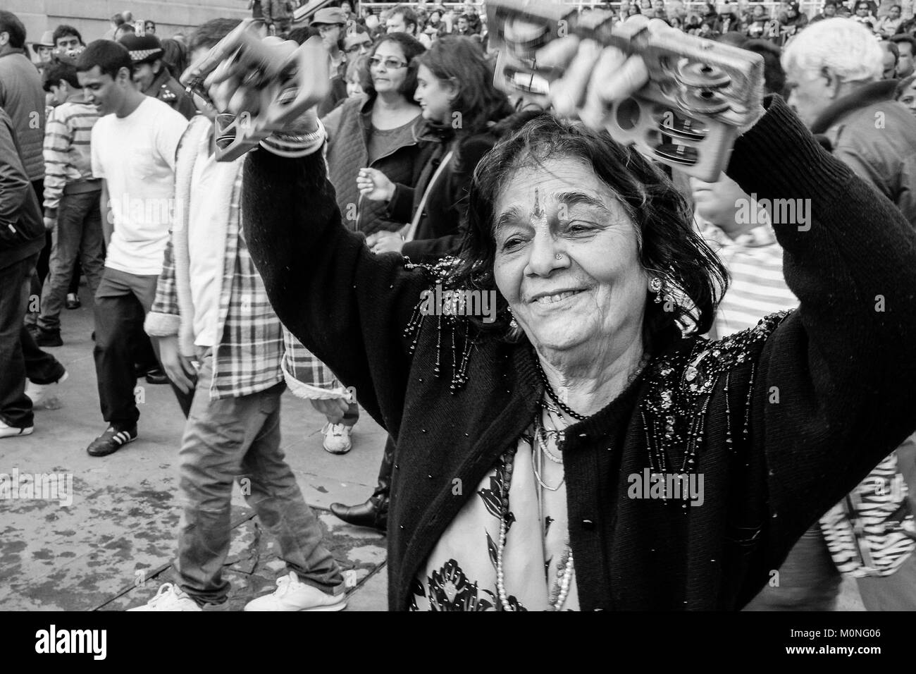 London black and white street photography: Indian woman dancing during Diwali celebrations. Stock Photo