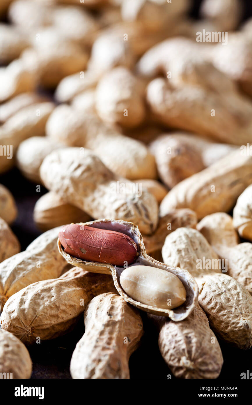 Whole and opened peanuts Stock Photo