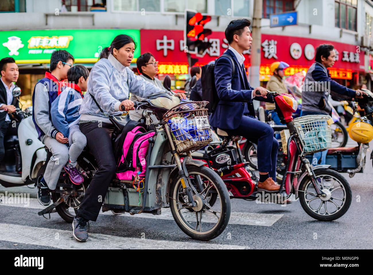 Shanghai, China. Mopeds crowd the streets of Shanghai, China. Credit: Benjamin Ginsberg Stock Photo