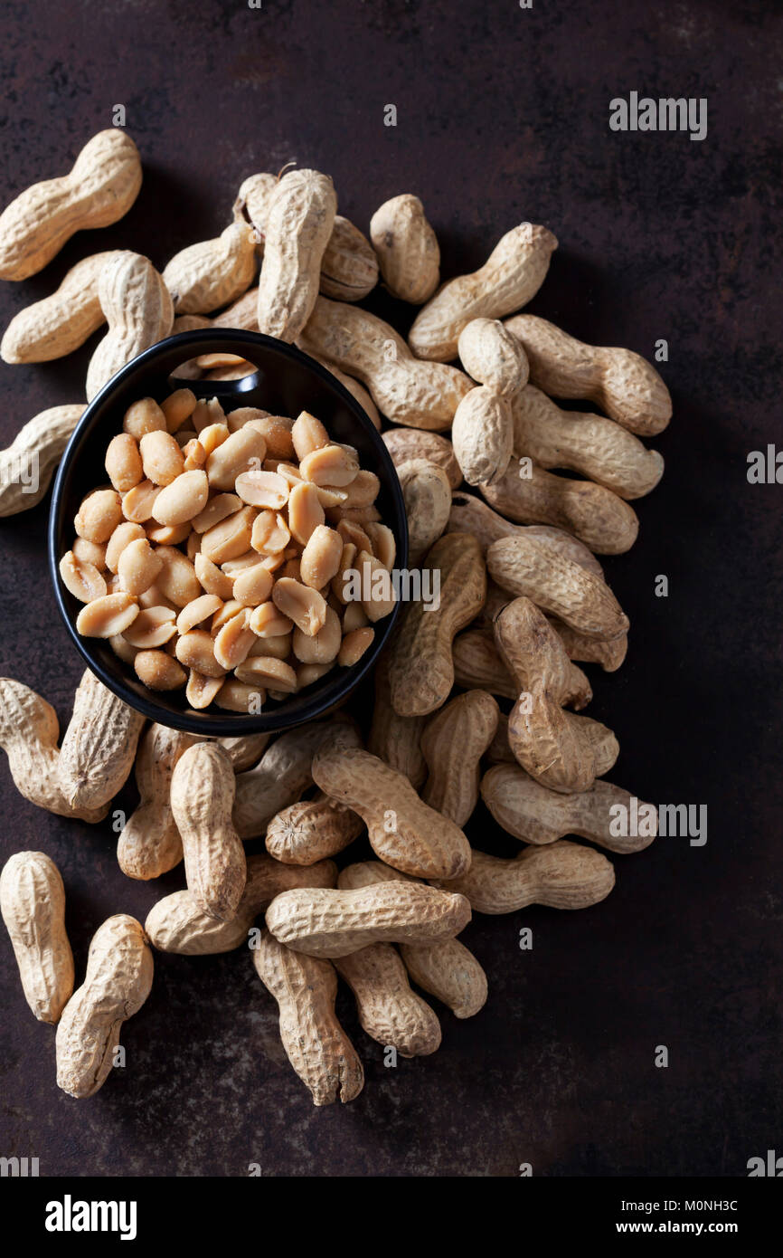 Bowl of salted peanuts and peanuts in shell Stock Photo