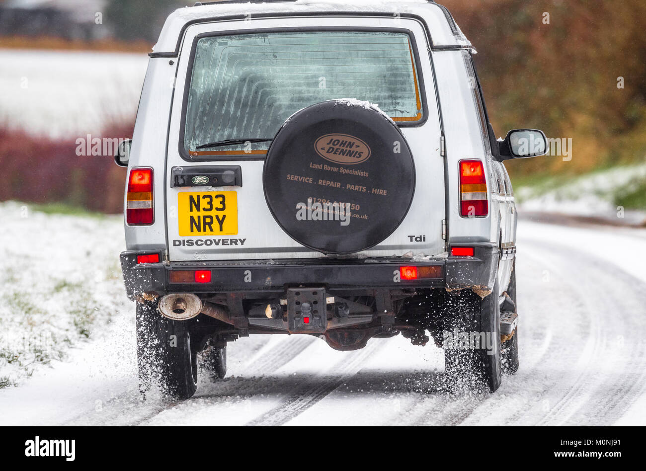 Series 1 land rover discovery driving down a snowy and icy road, Stock Photo