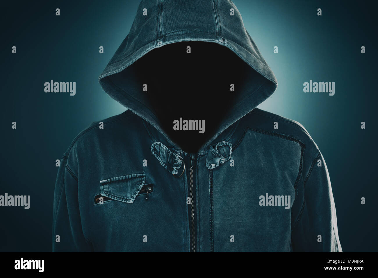 Mysterious suspicious faceless man with hoodie, dark low key portrait for crime and violence concepts Stock Photo