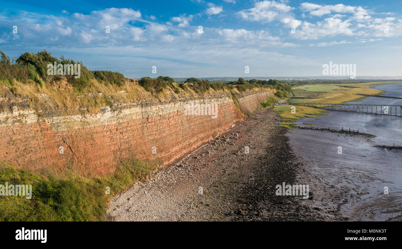 View of Aust Cliff, a famous geological locality and Site of Special Scientific Interest (SSSI), from the Severn Bridge. Stock Photo