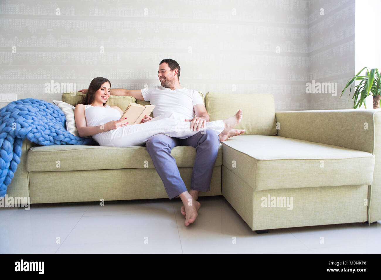 Pregnant woman and young man together indoors Stock Photo - Alamy