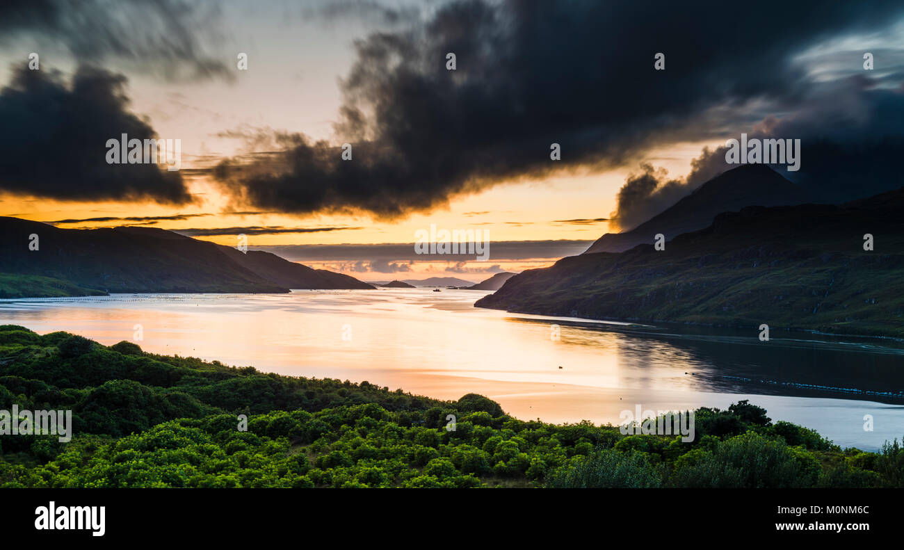 Looking west at dusk along the fjord of Killary Harbour on a still summer evening after sunset from Leenane, Connemara, County Galway, Ireland Stock Photo