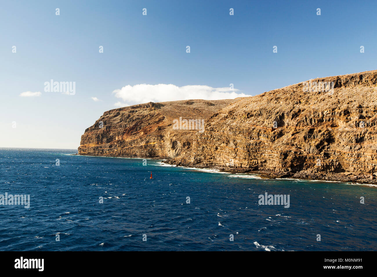 Sea cliffs and ancient terracing on La Gomera in the Canary Islands, near San Sebastian. Stock Photo