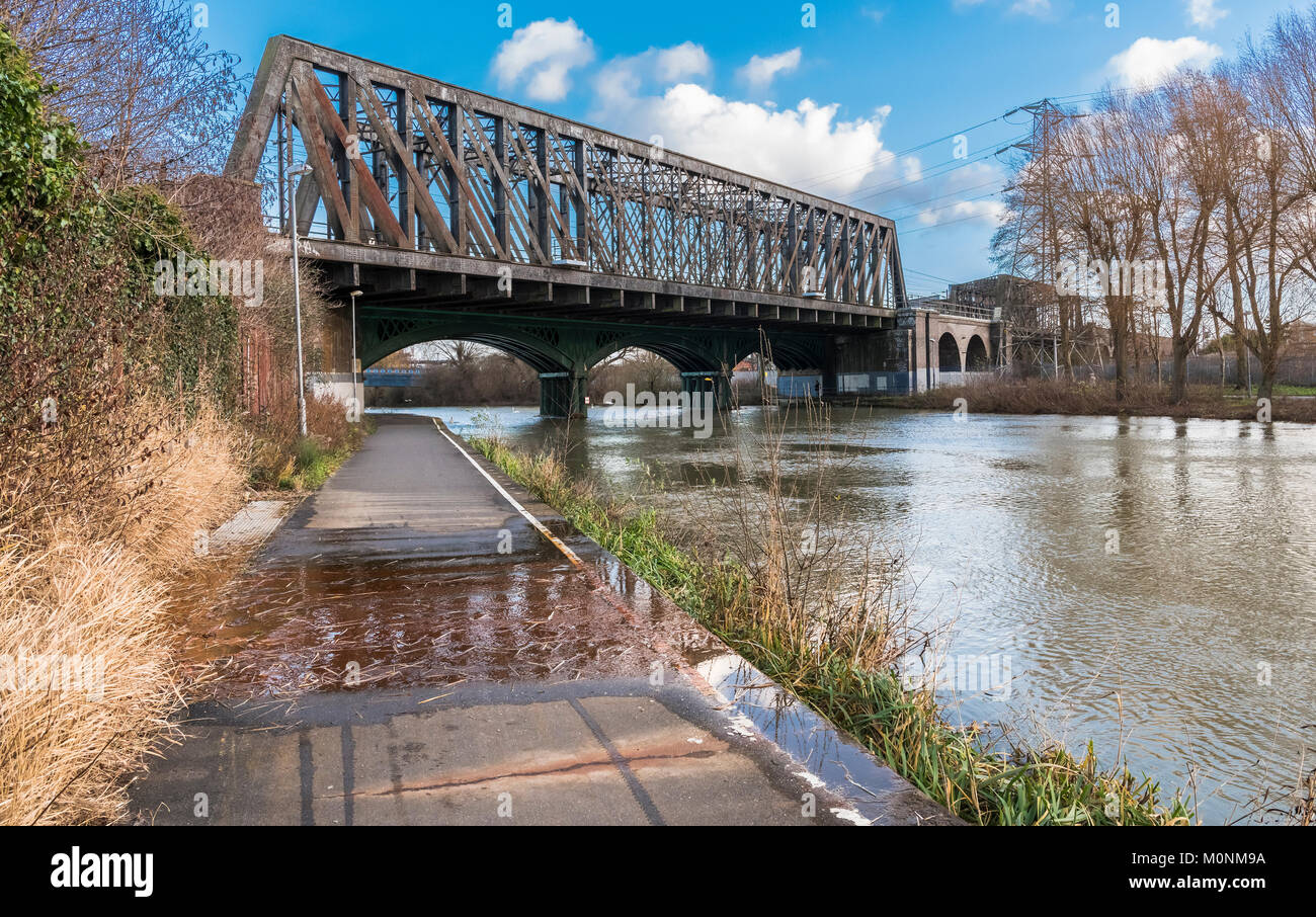 The 19th century cast iron railway bridge over the River Nene in central Peterborough which is still in use on the East Coast Mainline Stock Photo