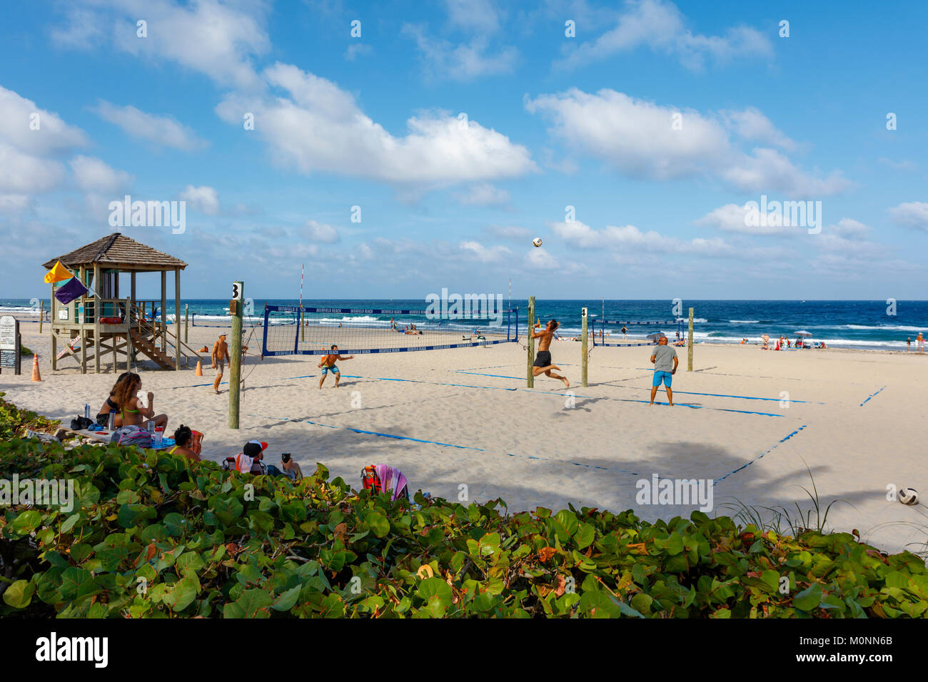 Men playing beach volleyball in Deerfield Beach, Florida, USA Stock