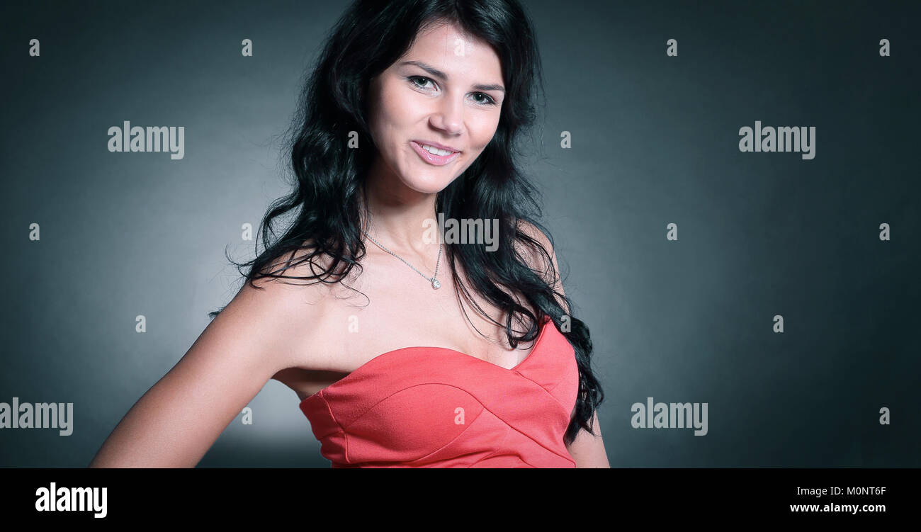 beautiful young woman in a red dress. isolated on black Stock Photo - Alamy