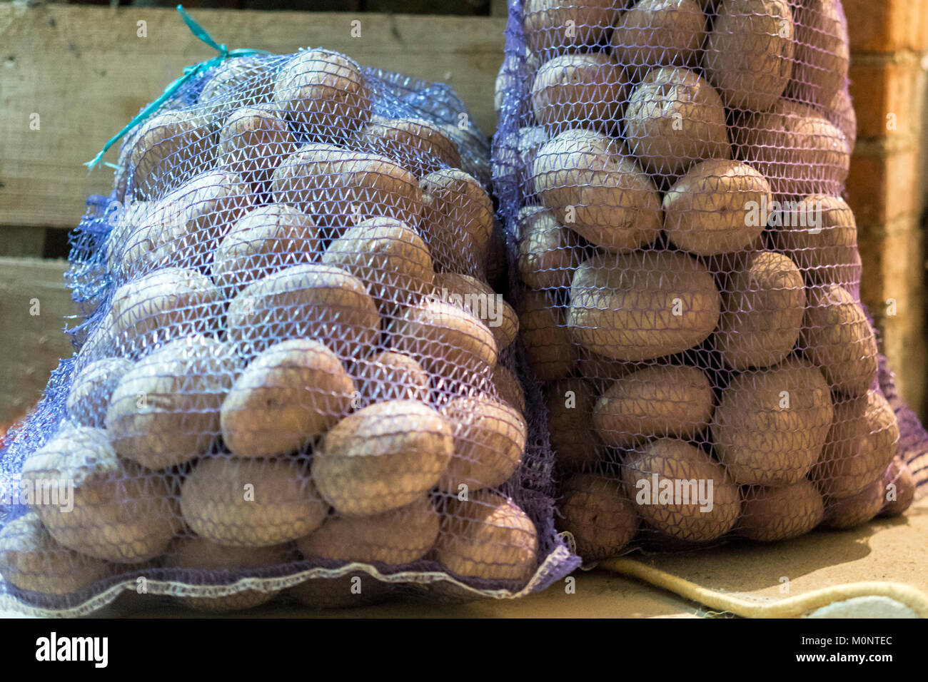 Two bags of potatoes in the basement Stock Photo Alamy