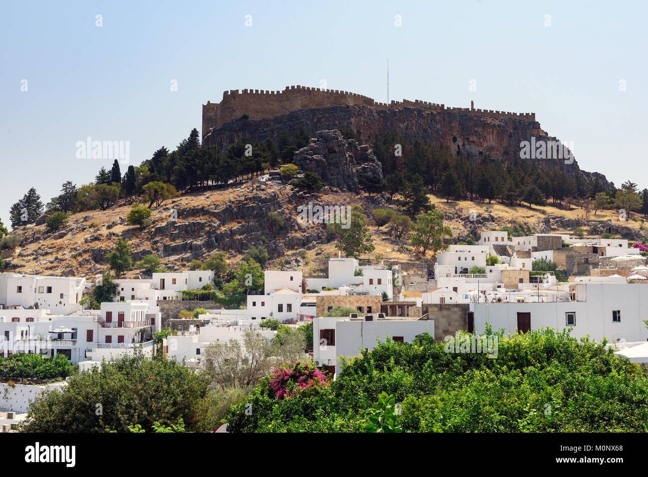 Panoramic view on Lindos town with a beautiful lagoon and ancient fortress on a hill at Rhodes island, Greec Stock Photo