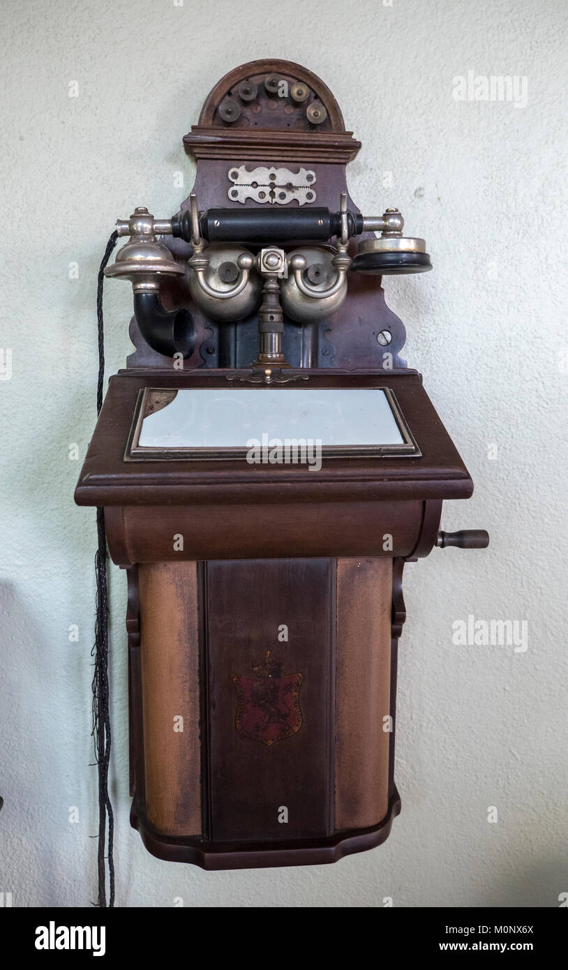 Antique Wooden Wall Phone Mexico Built As A Cabinet With Writting Desk For Taking Notes Stock Photo