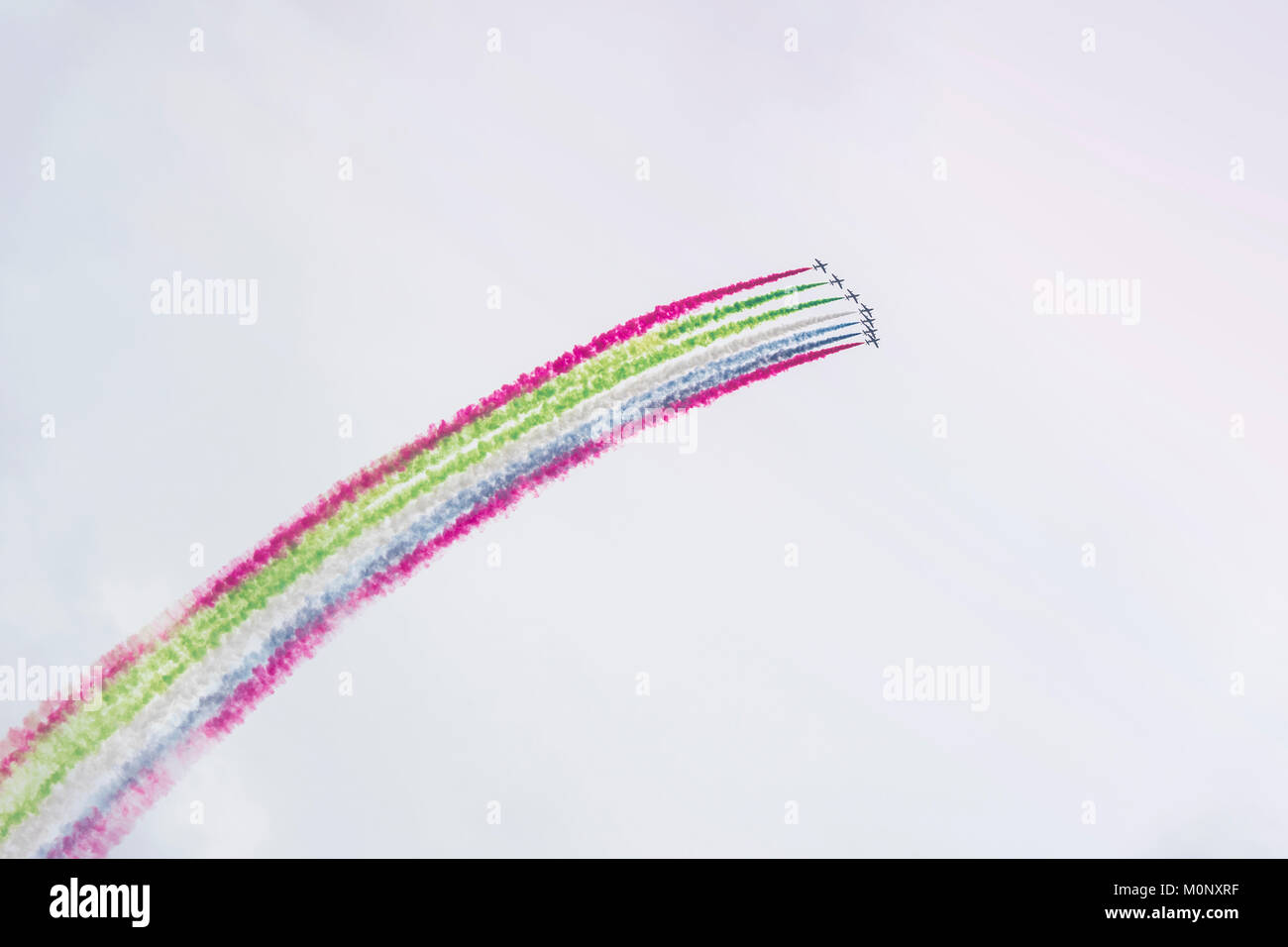 Airplanes on airshow with colorful bright trails of smoke against a