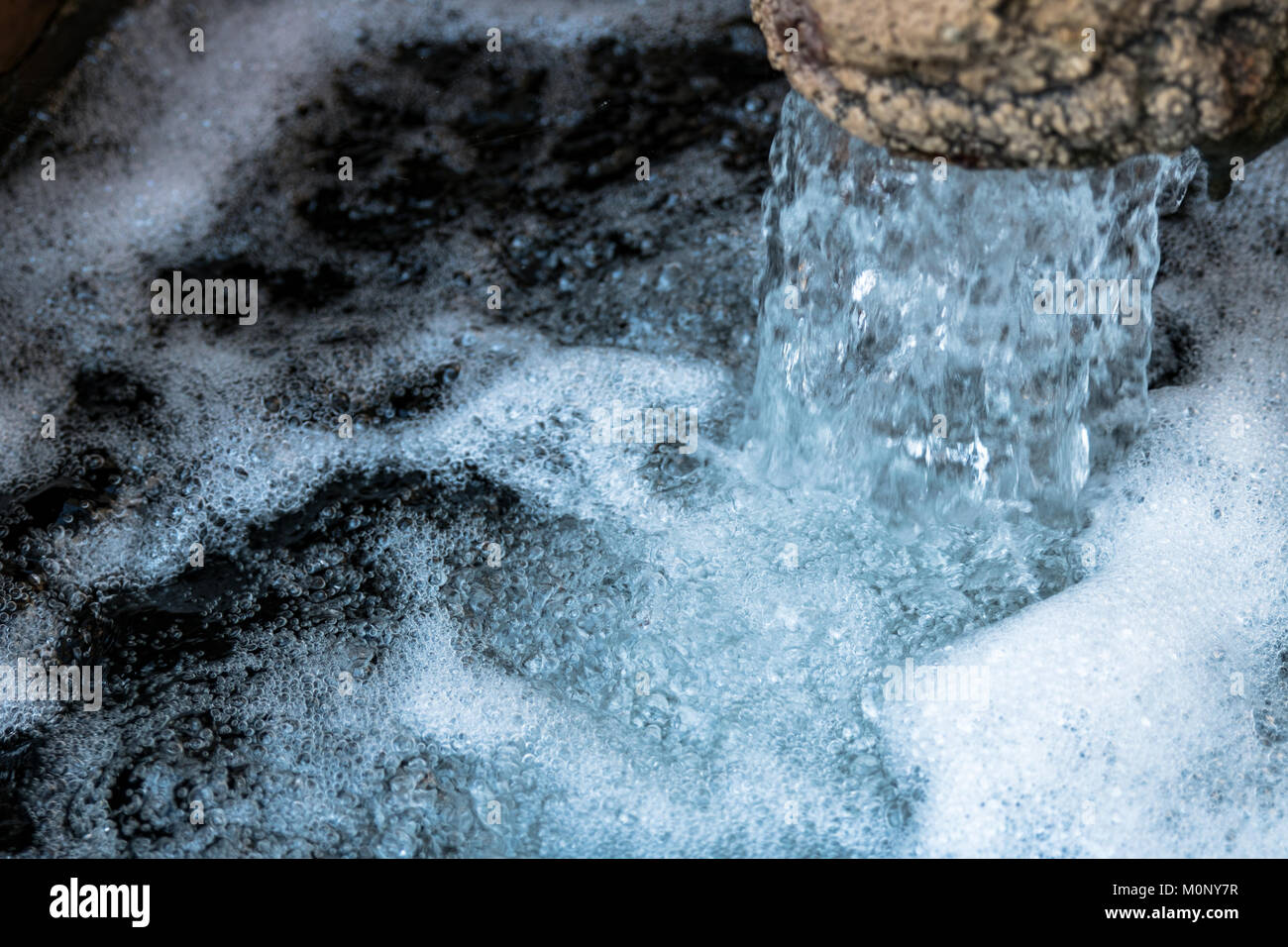CLose-up on a water fountain, showing clear, cristaline, sweet, drinking water. Stock Photo