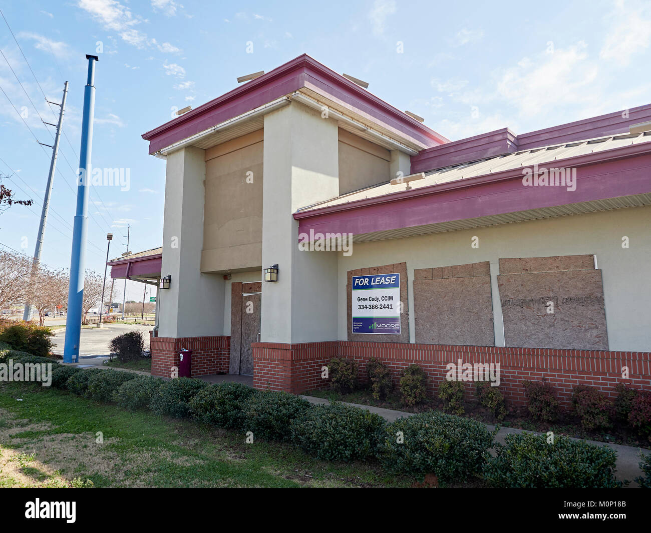 Boarded up and shuttered business with an empty parking lot in Montgomery Alabama, United States. Stock Photo