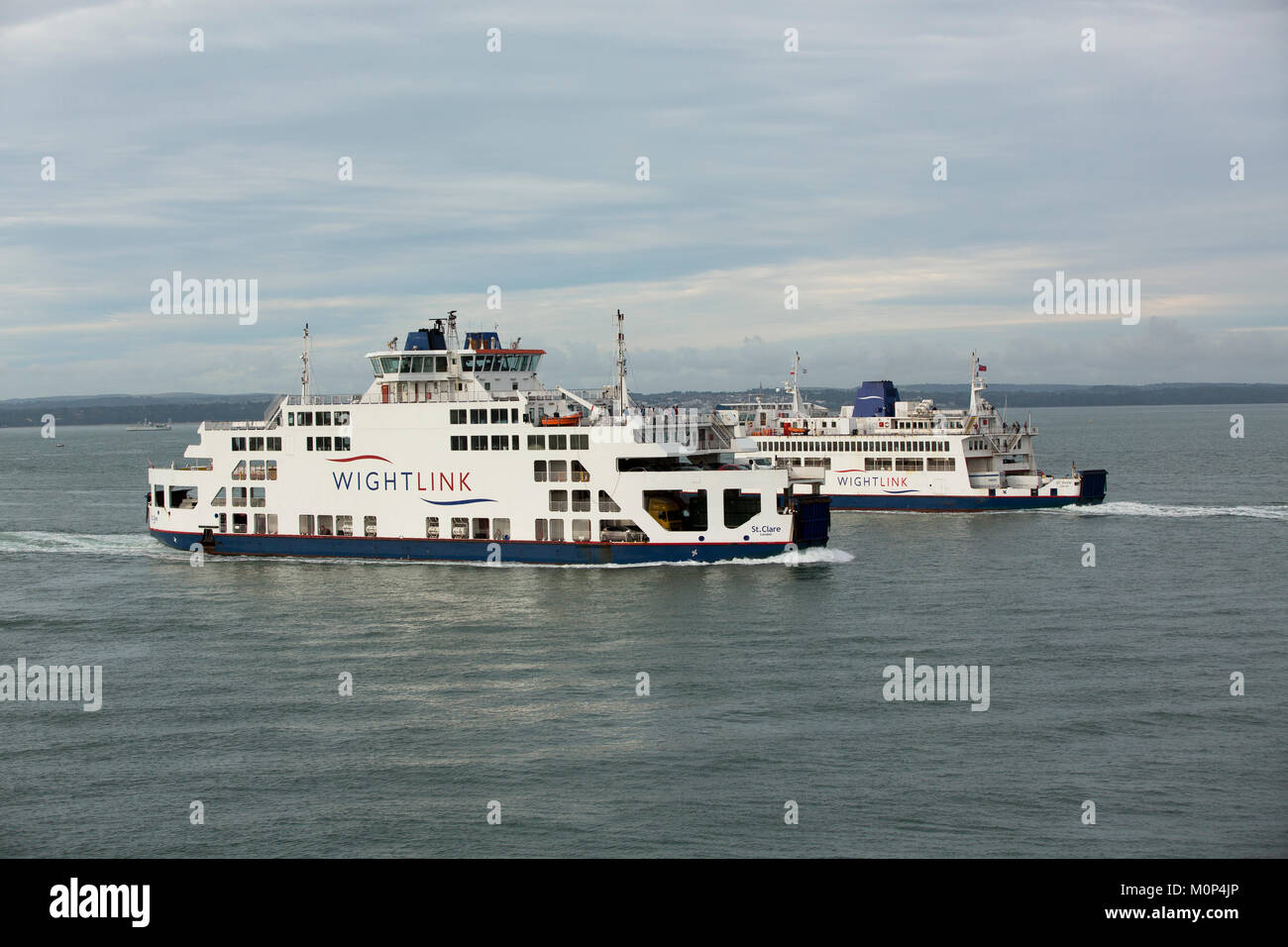 Wightlink car ferries St Faith and St Clare passing each other in the Solent. Inbound and outbound services of two generations of ferry. Stock Photo