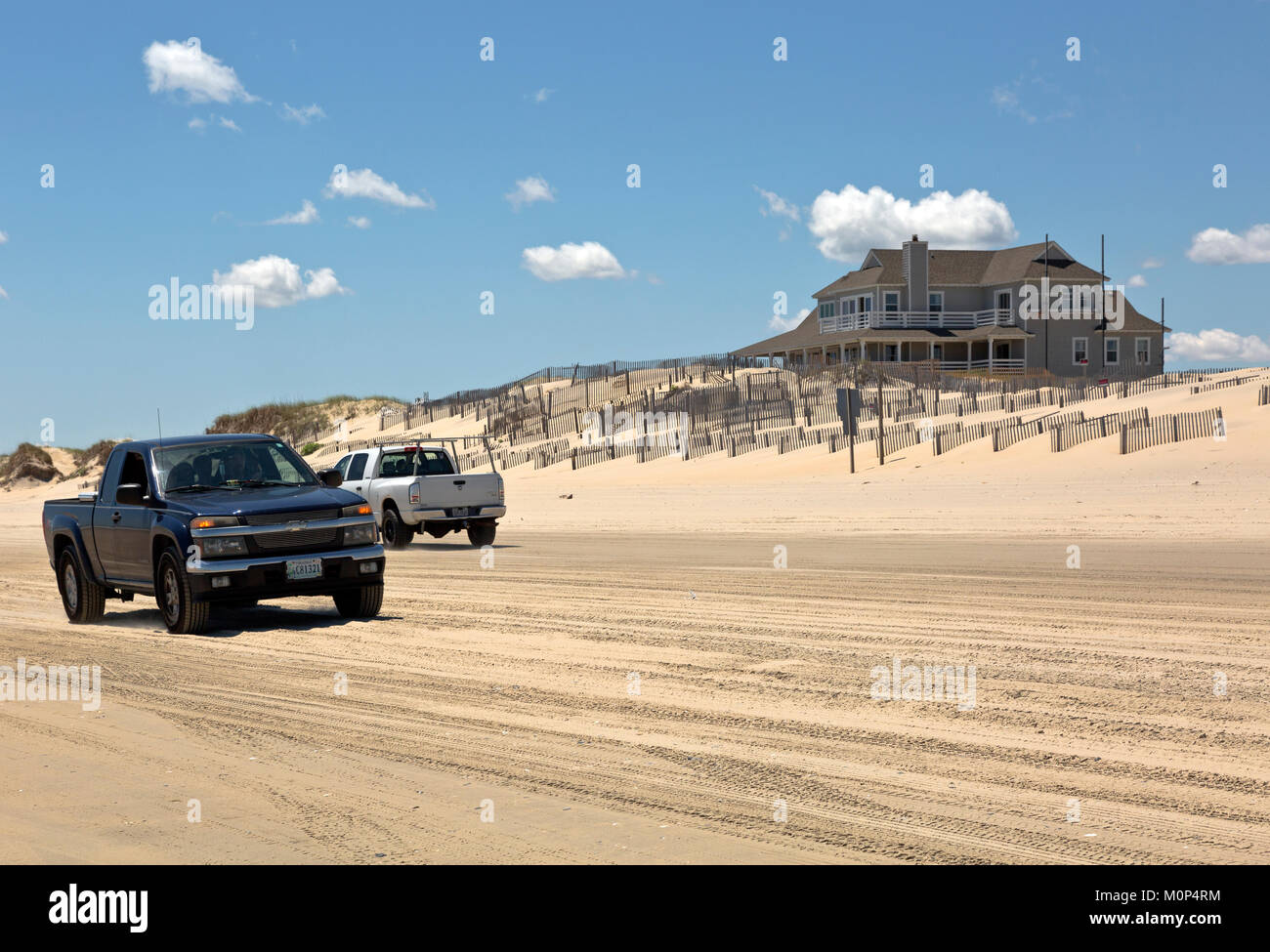 NC01410-00...NORTH CAROLINA - Sand fences attempt to stablize a sand dune along the Atlantic Coast at the edge of a housing developement located beyon Stock Photo
