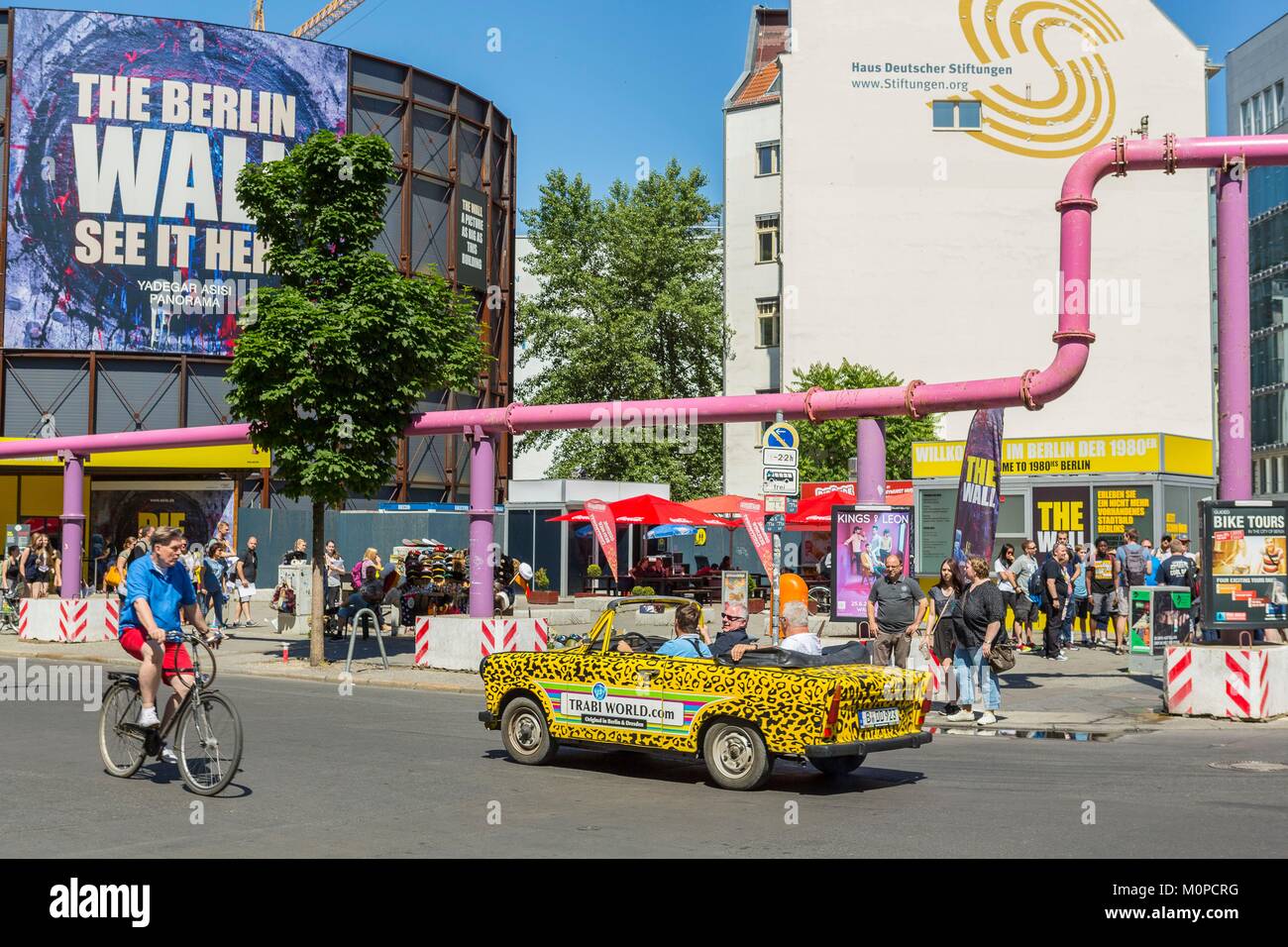 Germany,Berlin,Checkpoint Charlie,tourist animation and old Trabant car to visit the city. Stock Photo