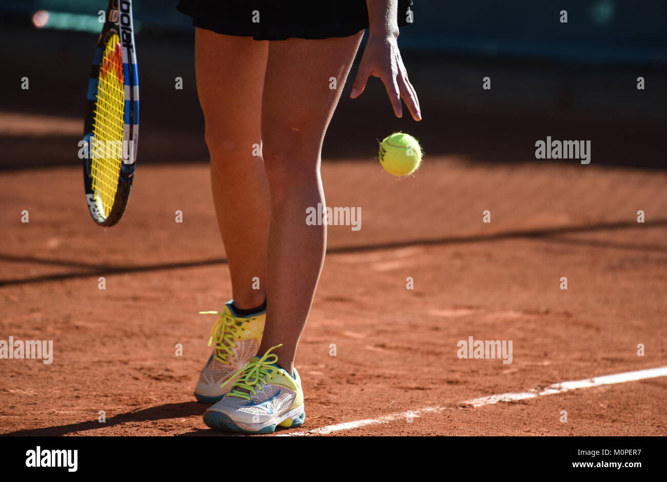 images of details of a women's tennis match,a tennis player prepares to