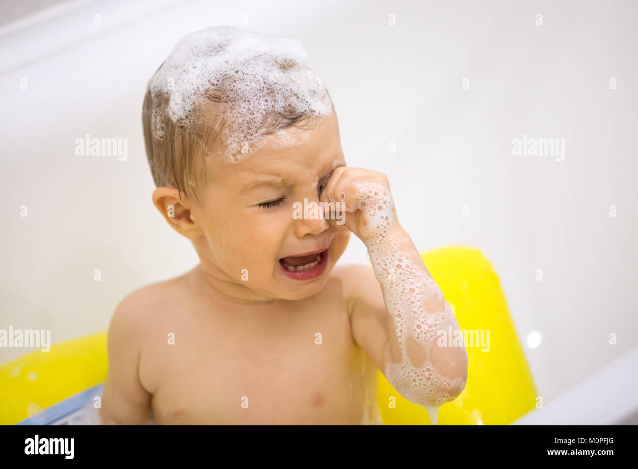 Cute toddler in tears crying taking a bath in bathtub Stock Photo Alamy