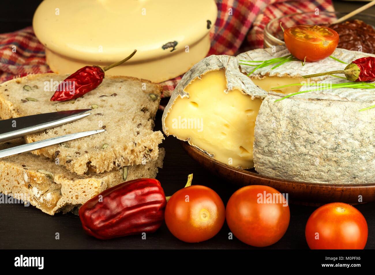 Domestic mature mold cheese with tomatoes. Dairy product. Aromatic cheese with mold Stock Photo