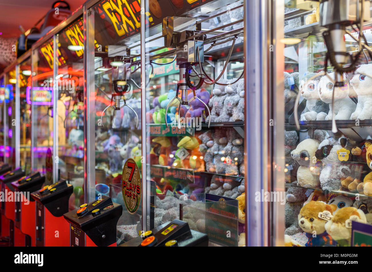 A row of coin operate cuddly toy grabbers in an amusement arcade, Llandudno, Wales, Uk. Stock Photo