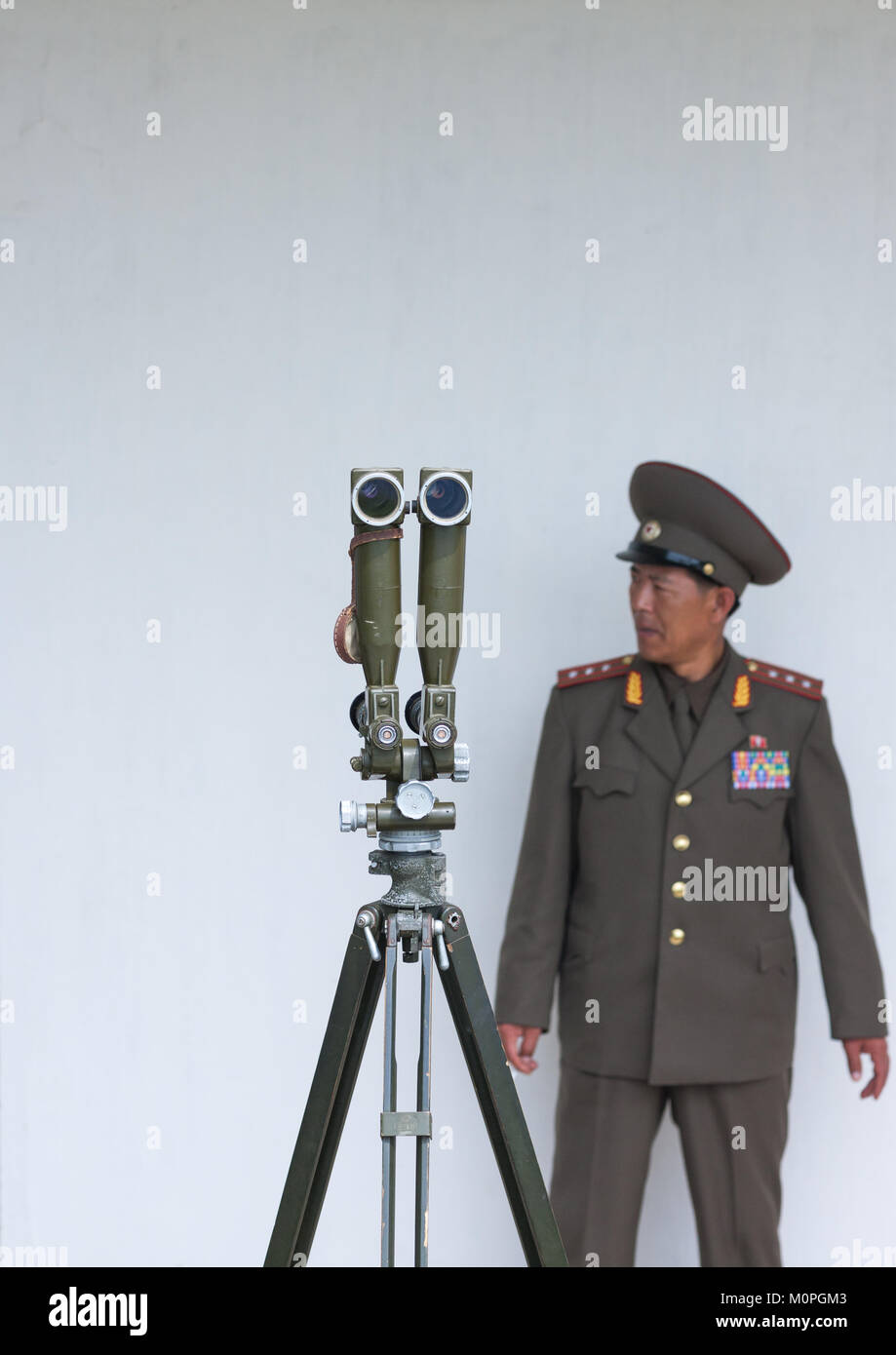 North Korean officer standing near binoculars on the Demilitarized Zone