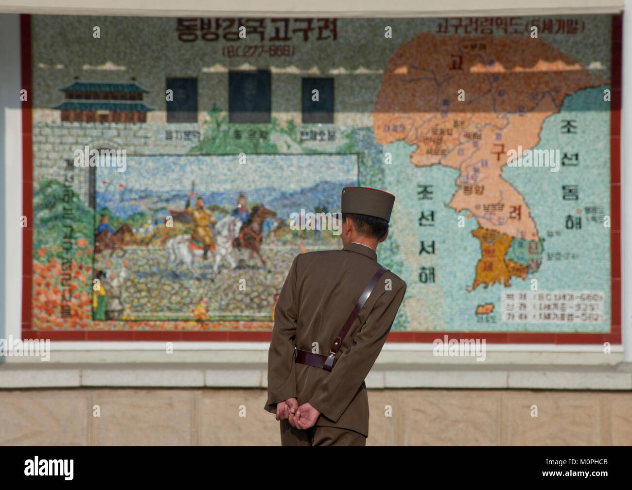 North Korean soldier looking at a Korea map in the street, North Hwanghae Province, Sariwon, North Korea Stock Photo