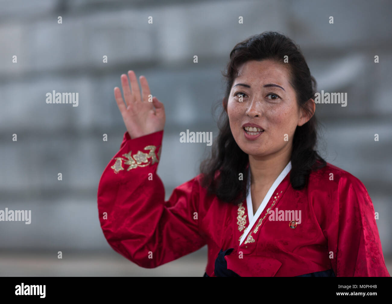 Portrait of a North Korean woman with hand raised, Pyongan Province