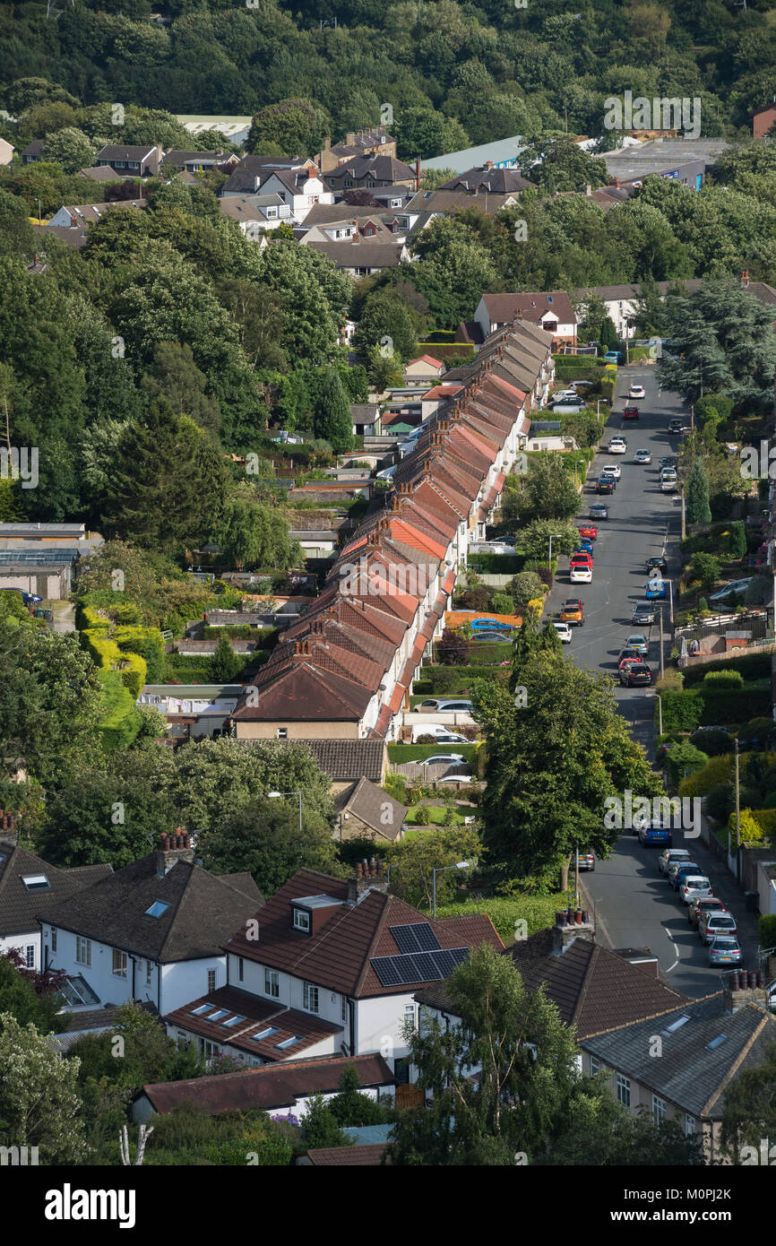 High view of area of Baildon town, with straight road of semi-detached houses in residential urban suburb - Bradford, West Yorkshire, England, UK. Stock Photo