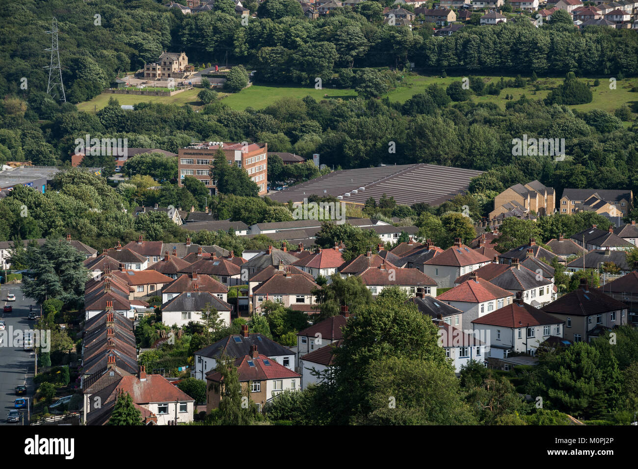 High view of Baildon town area - semi-detached houses in residential urban suburb & industrial units beyond. Bradford, West Yorkshire, England, UK. Stock Photo