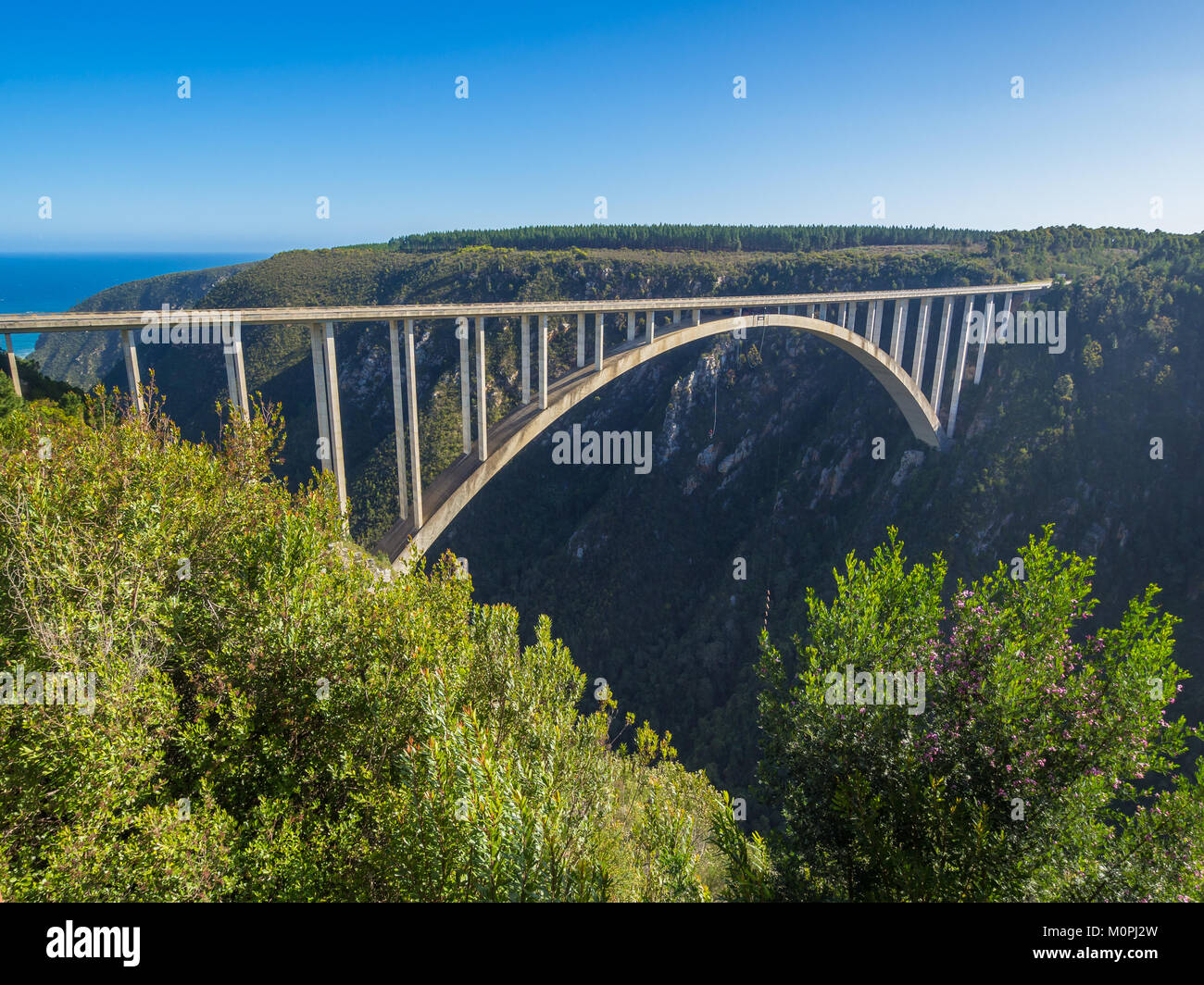 Garden Route - Famous Bloukrans Bridge with ocean in background and bungee jumpers, South Africa Stock Photo