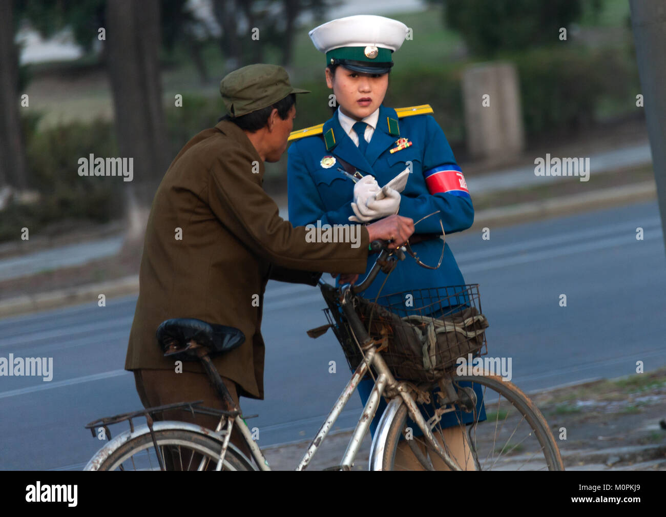 North Korean man with a traffic officier woman in the street, Pyongan Province, Pyongyang, North Korea Stock Photo