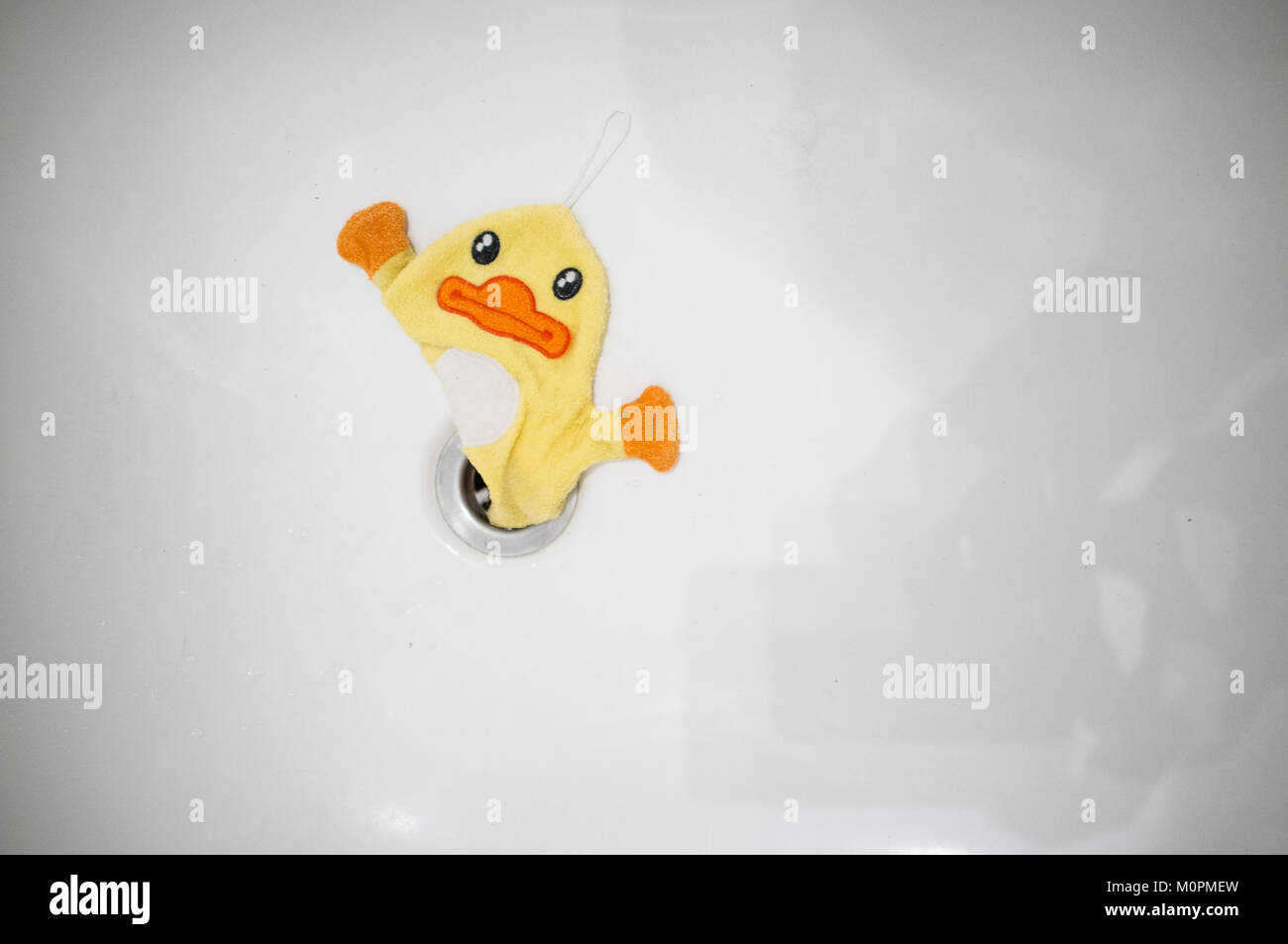 Children's flannel shaped like a duck in a bath Stock Photo