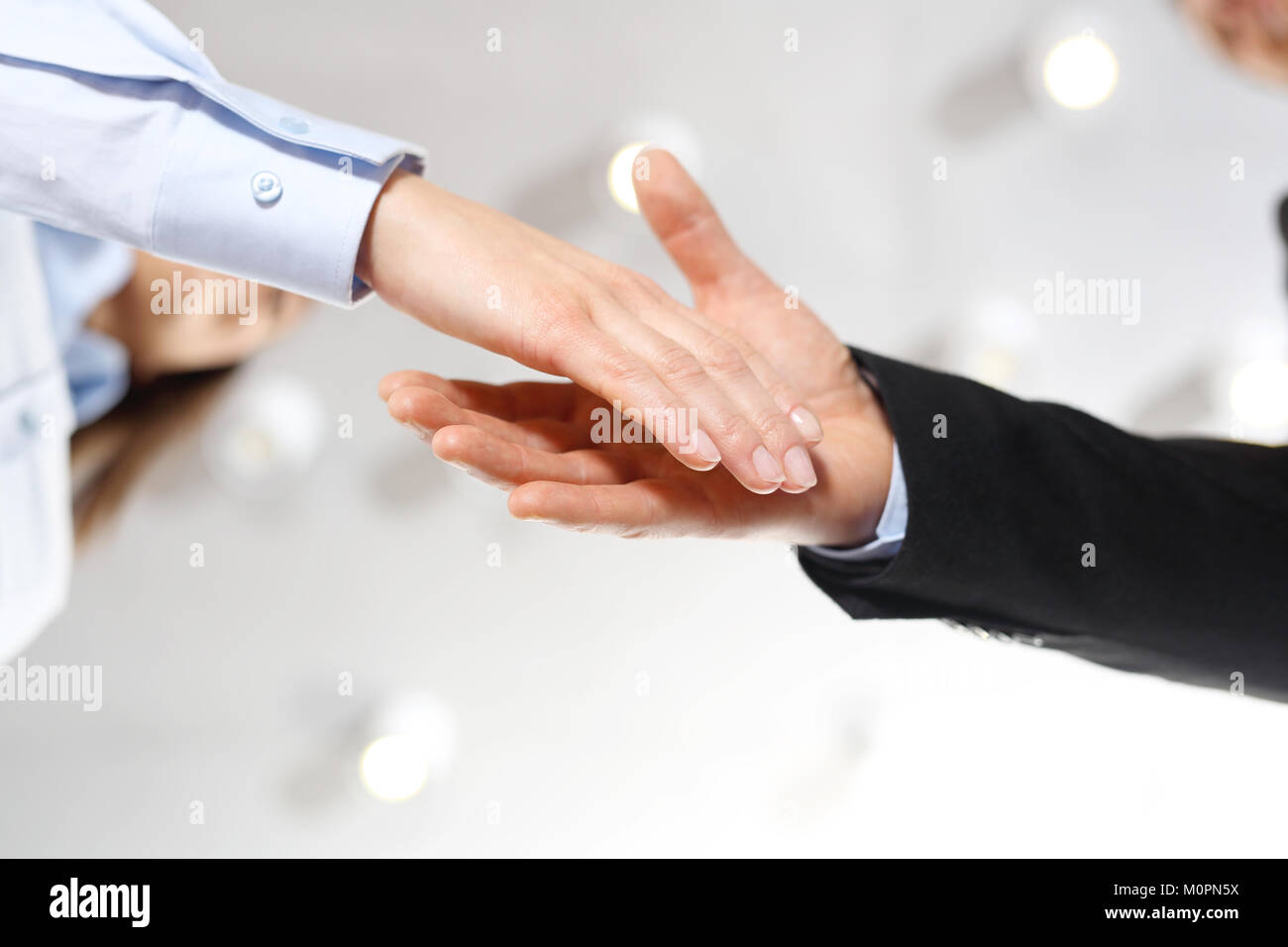 Congratulations. Welcome new employee of the company. Hand of a woman and a man in office clothes during a welcome gesture. Stock Photo