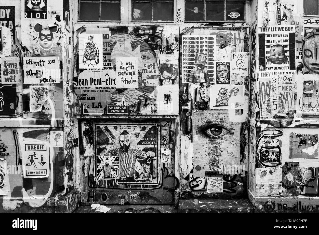 London Black and white urban photography: Wall covered with posters, Brick Lane, East London. Stock Photo