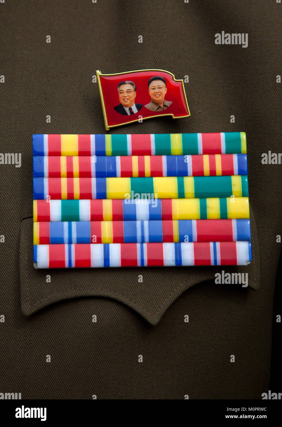 Dear Leaders badges and medals on an officer vest, North Hwanghae Province, Panmunjom, North Korea Stock Photo