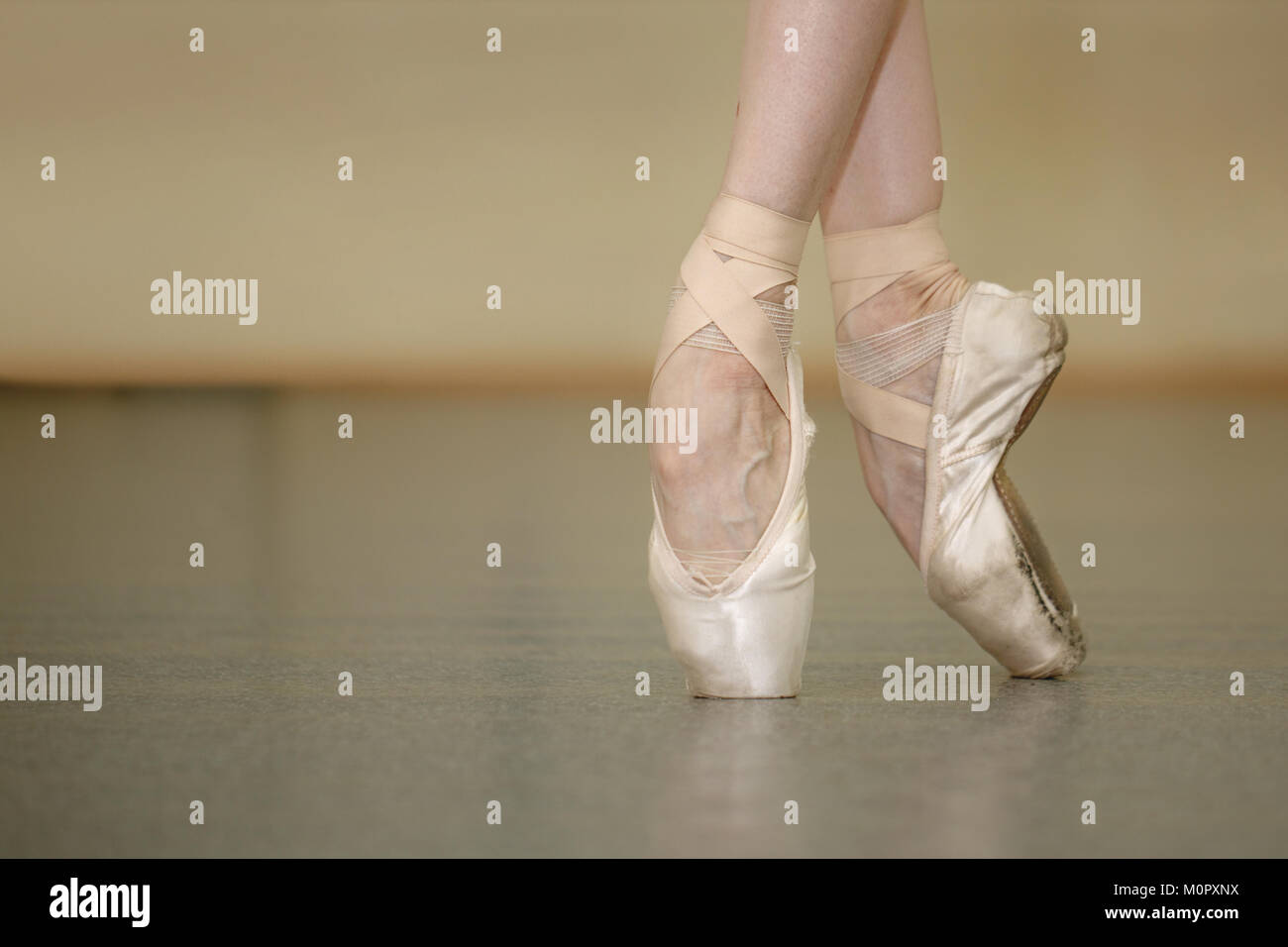 Slender ballerina feet in pointe shoes. Shooting close-ups Stock Photo